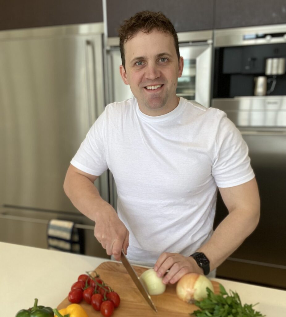 Chef Jon Watts chopping veg in a kitchen