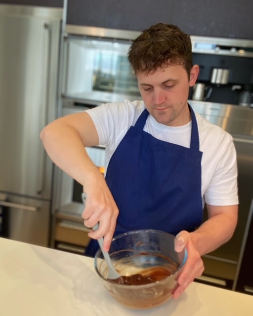 Chef Jon Watts mixing chocolate in the kitchen