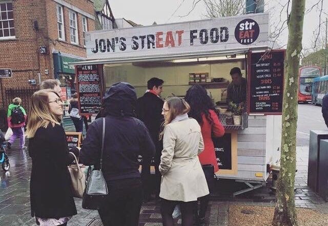 Chef Jon Watts serving food in his street food van in St Albans